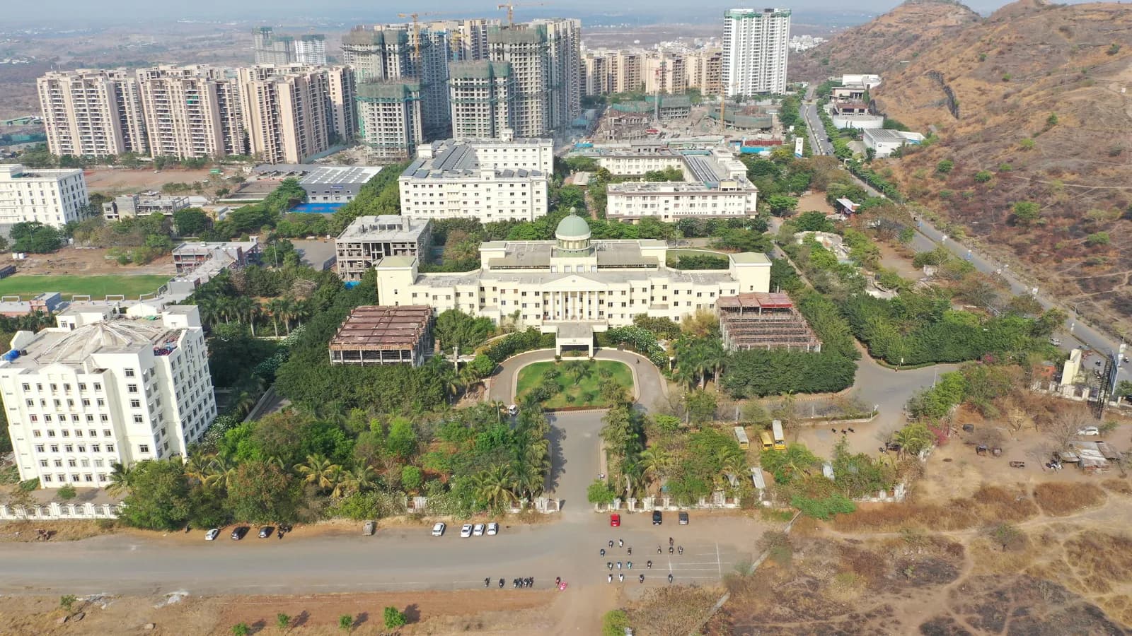 Aerial view of Ajeenkya DY Patil University campus with hills in the background, Pune