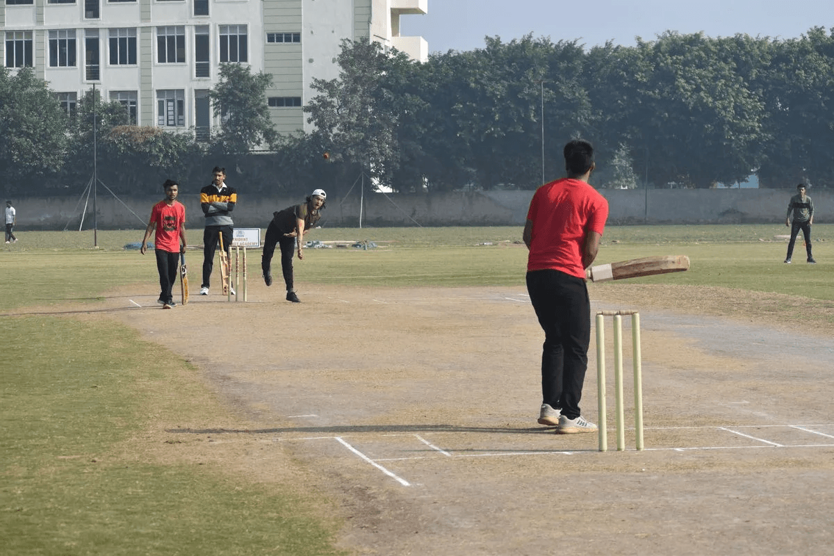 Students playing cricket on the Hi-Tech Institute grounds, Ghaziabad