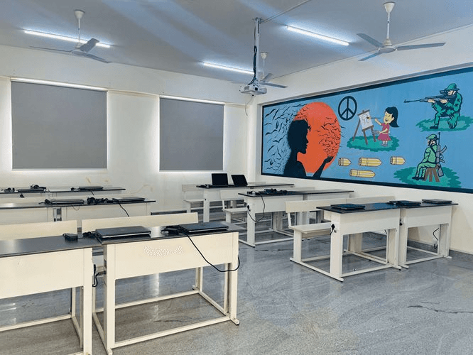 Laptop-equipped classroom with colorful mural, Rathinam campus